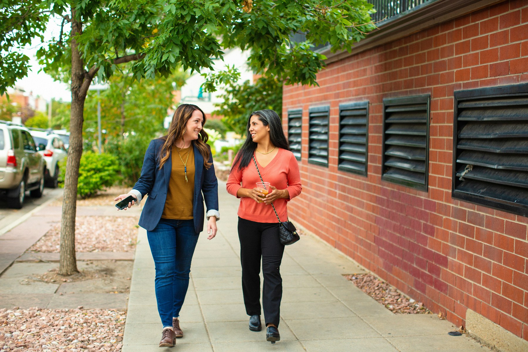 Two people enjoying a conversation on a walk outside